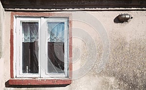 Old wooden window in a weathered building, color toning applied