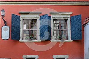 Old wooden windows with metal shutters