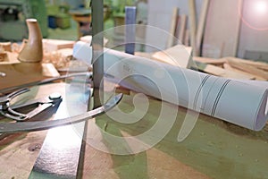 Old woodworking hand tools: wooden plane, chisel and carpentry workshop on a table covered with sawdust, side view