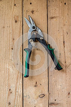 Old work tools hang on the wooden wall.