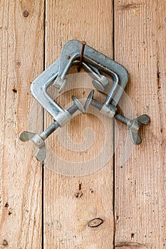 Old work tools hang on the wooden wall.