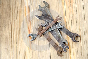 Old work tools spanner, wrench on a wooden table.