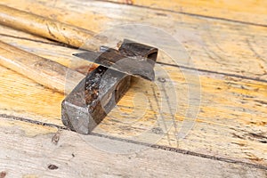 Old working tools ax and hammer lie on wooden surface background construction