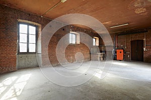 Old workshop interior with brick walls and windows