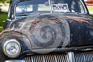 Old and worn beat up car from the forties for sale