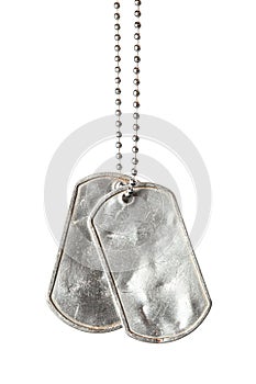 Old and worn blank military dog tags with chain isolated