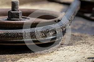 Old, worn, cracked drive belt on lawn mower deck