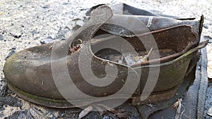 Old worn discarded leather boot
