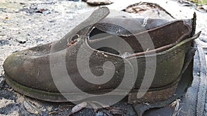 Old worn discarded leather boot