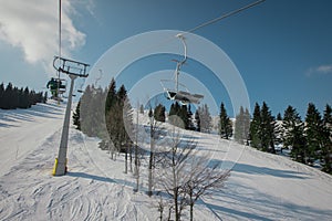 Old and worn gondola or ski lift on Soriska planina in slovenia on a sunny winter day
