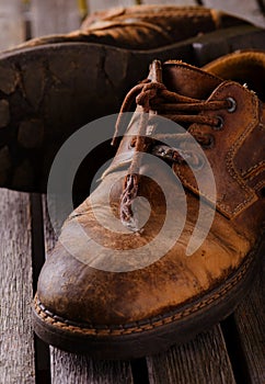 Old worn laces on brown leather boots