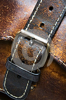 Old worn leather bag buckle detail