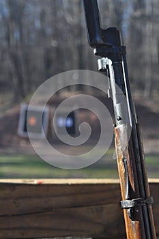 Weathered Mosin Nagant Wood Gun Rifle Stock with Bayonet Attached and Targets in the Background