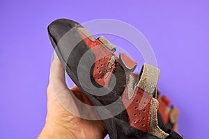 Old and worn-out climbing boots. Repair of climbing shoes. The repairman re-stick the rubber of the shoes.