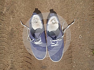 Old worn out and dirty blue sneakers