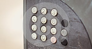 Old worn out and dirty keypad on a street