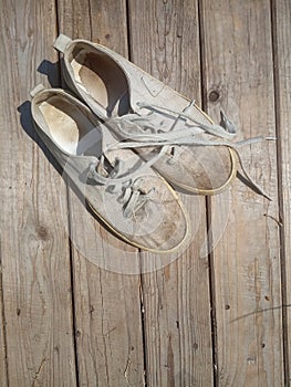 Old worn out and dirty white sneakers