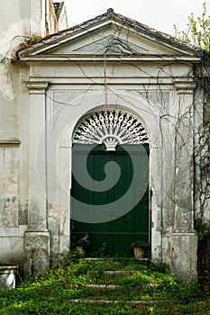 Old worn-out doors in a historic stone house of the 18th-19th centuries. Travel to European cities, southern Italy, old retro