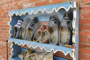 Old worn-out Dutch clogs in a rack
