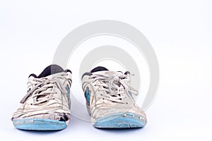 Old worn out futsal sports shoes on white background