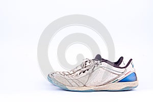 Old worn out futsal sports shoes on white background isolated