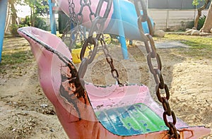 Old Worn out Playground Swing in the Hazy Sun