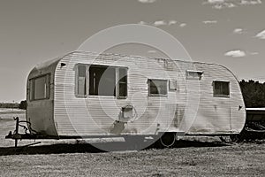 Old worn out pull camper black and white