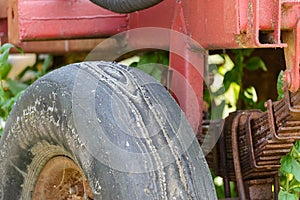 Old worn out truck tire with abrasions and layers of rubber