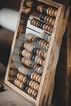 Old worn out wooden abacus on a table