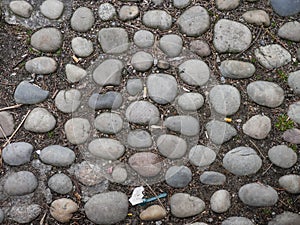 Old worn round cobblestones on a walkway.