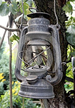 Old worn rusty kerosene hurricane lamp.