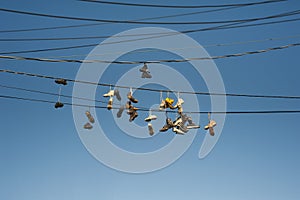 Old Worn Sneakers Hanging On Telephone Wires