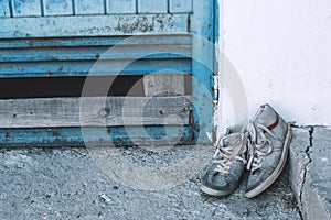 Old worn sneakers on the street