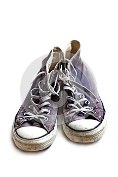 Old worn sneakers on white background