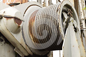 Old worn steel cable on rusty roller