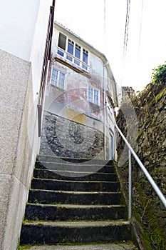 Old worn stone stairs for use in a neighborhood of old houses wi