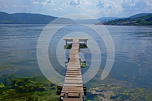 Old worn wooden pier on the border of Danube river