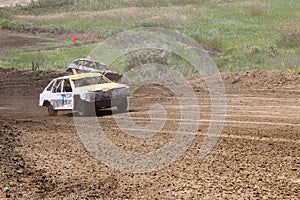 Old wrecked cars stock race. Racing in open air with dust