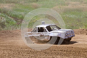 Old wrecked cars stock race. Racing in open air with dust