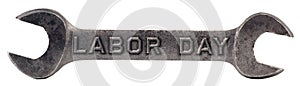 Old wrench isolated on white with the words Labor Day stamped into metal