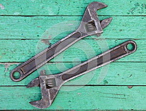 Old wrench on wooden background
