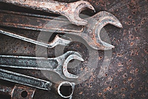 Old wrenches tools on rusty metal table