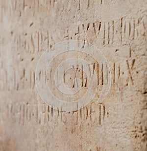 Old writing carved on a stone shallow depth