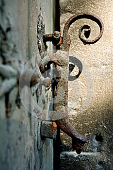 Old wrought iron door knocker placed on a wooden door 5. photo