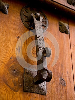 Old wrought iron door knocker placed on a wooden door 6. photo