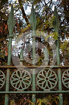 Old wrought iron fence. Vintage look. Detail of an ornament