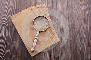 Old yellow books and magnifiers on the table photo