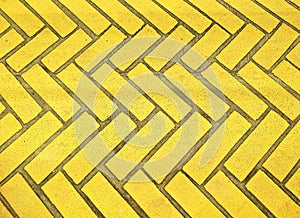The old yellow bricks stone floor with zigzag pattern texture background