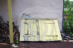 The old yellow cellar door has been weathered by all the years.