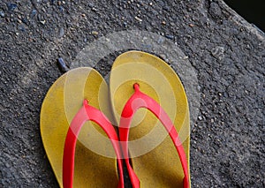 Old yellow flip flop on street